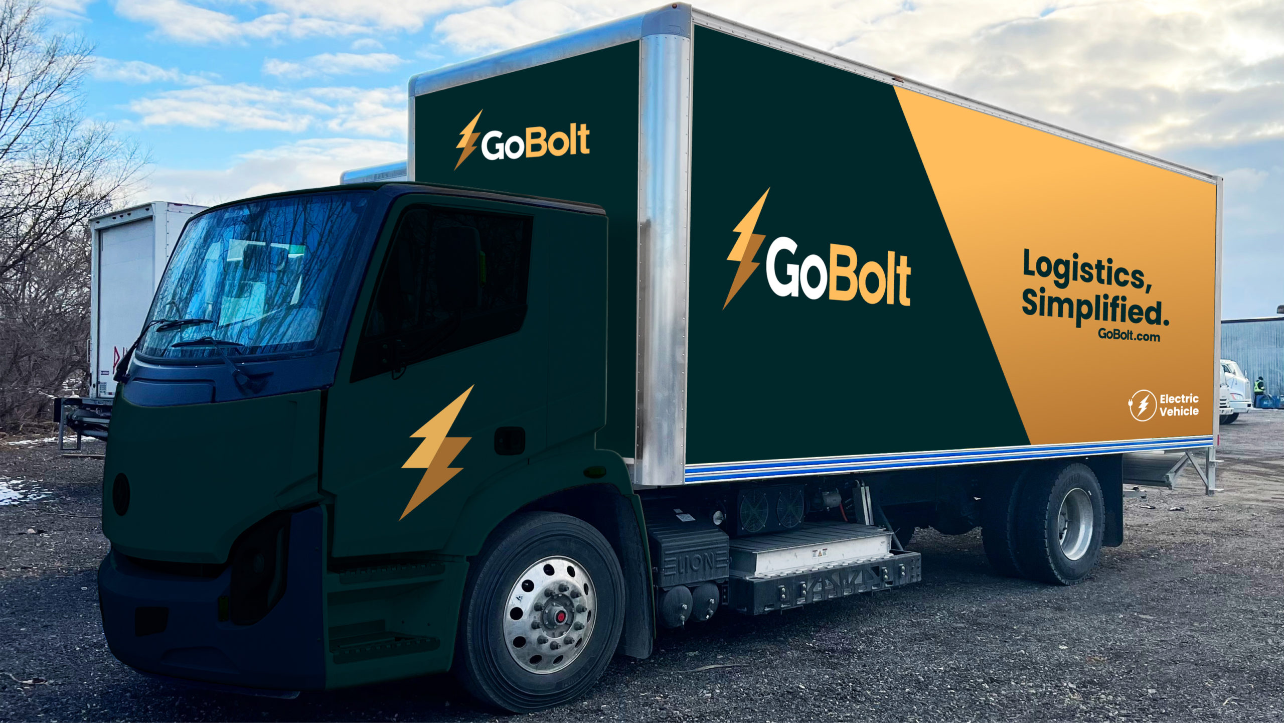 A GoBolt delivery truck with a green and gold design is parked outdoors.