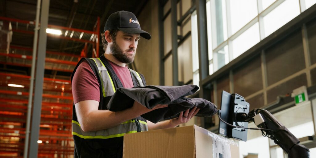 An image of a GoBolt warehouse worker using technology to process an ecommerce return