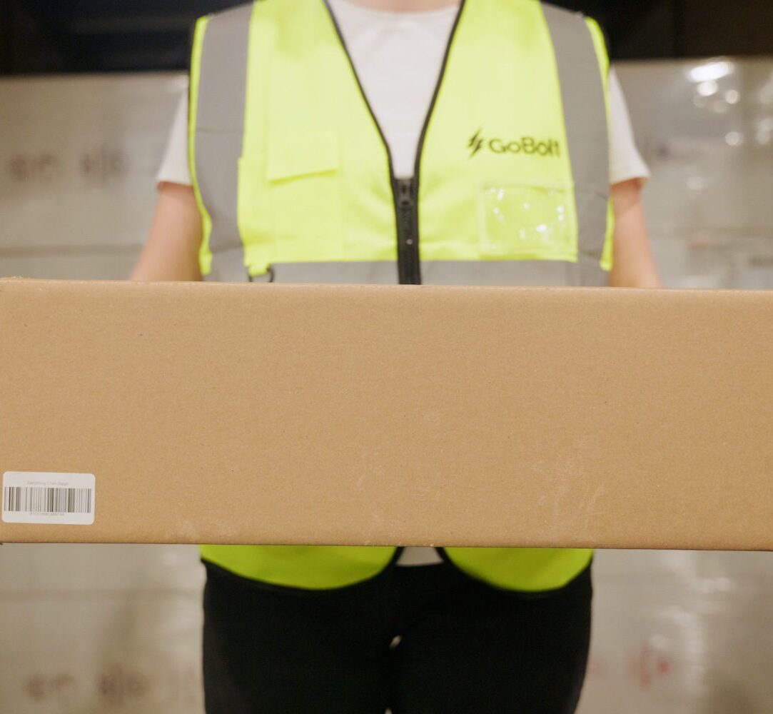 Person holding a package in warehouse